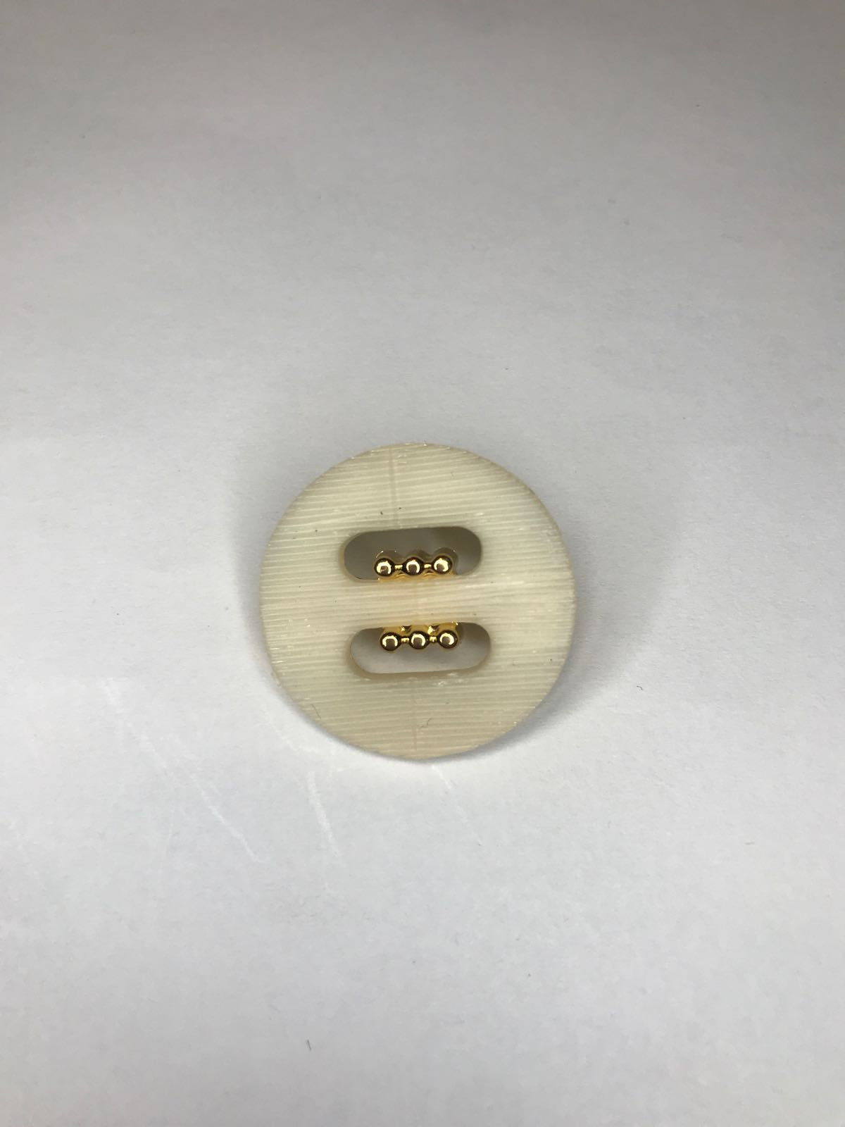 Plastic button with gold 25 mm